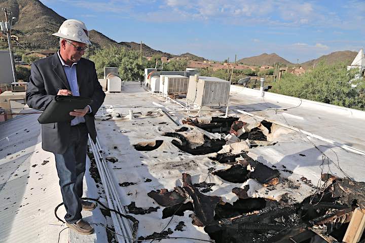 What does a public insurance adjuster do? Public Insurance Adjuster on the roof of a building after a fire.